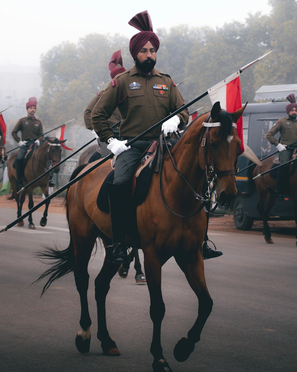 a man in a uniform riding a horse