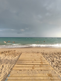 a wooden walkway leading to a beach