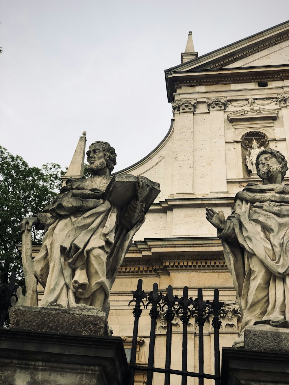 a statue of a person holding a book