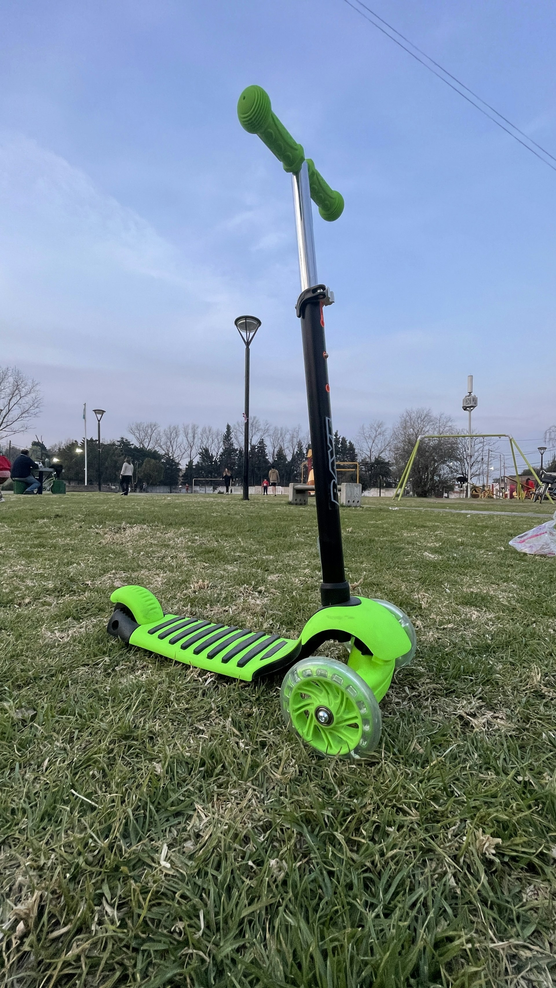 a green lawn mower on a grass field