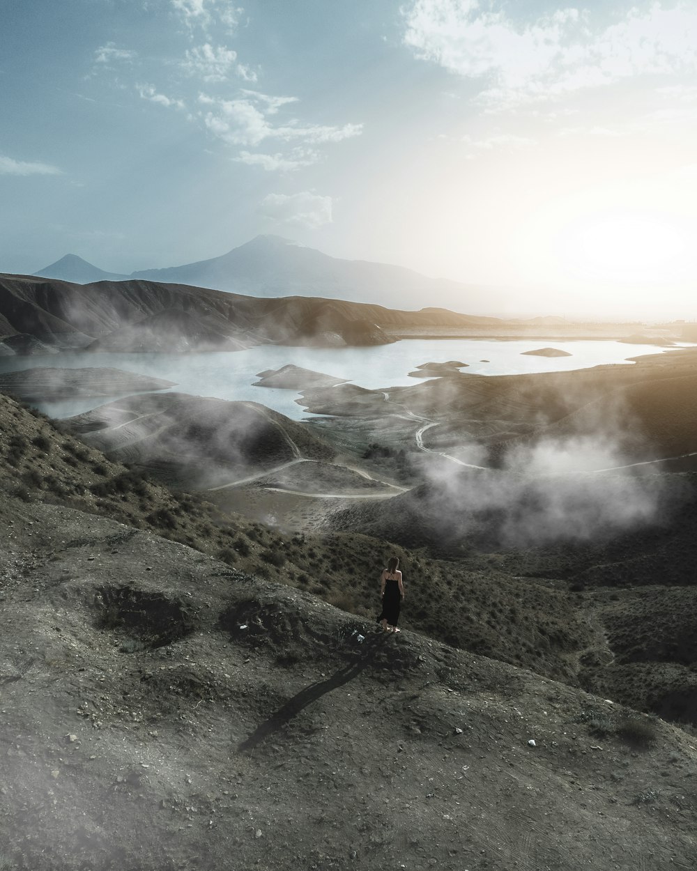 a person standing on a rocky hillside