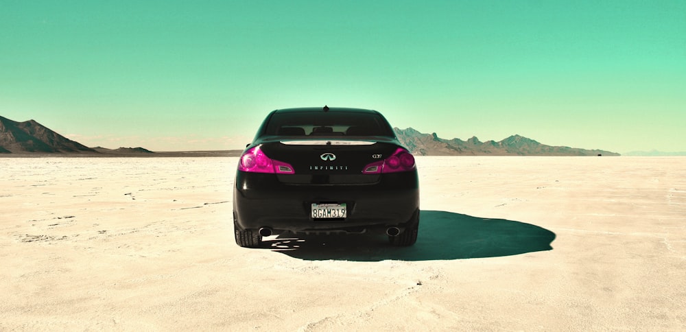 a car driving on a desert road