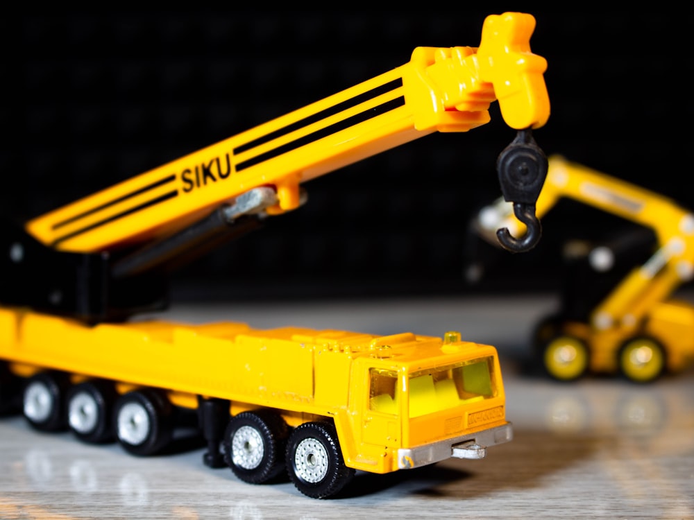 a toy truck with a yellow toy truck