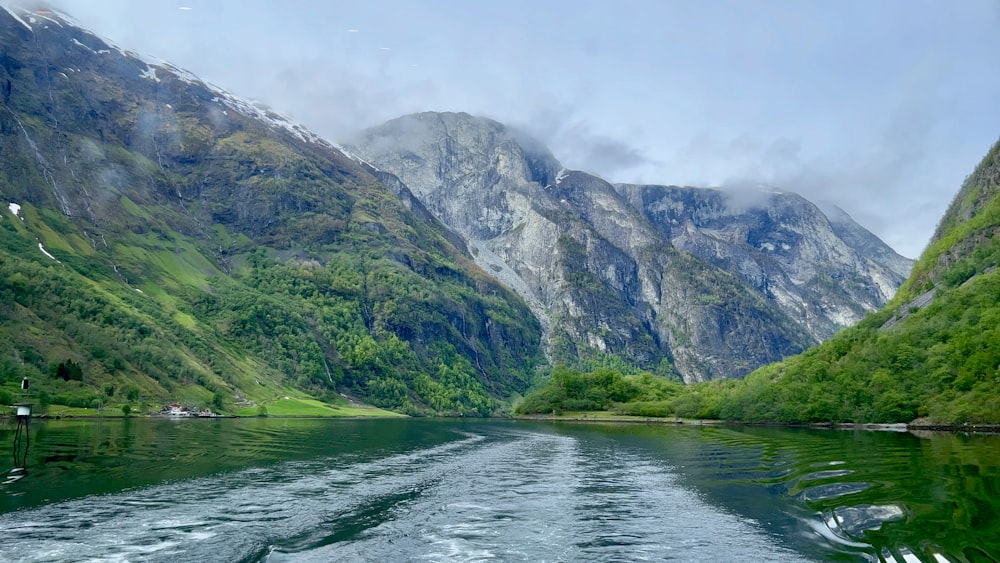 a body of water with mountains in the back