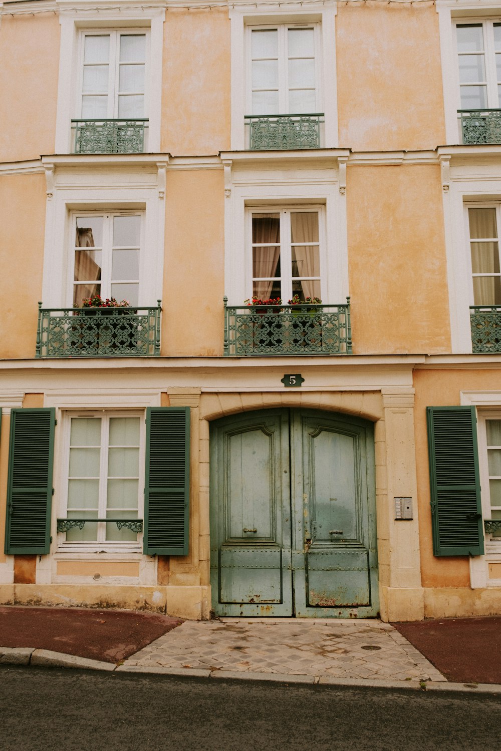 a building with green shutters