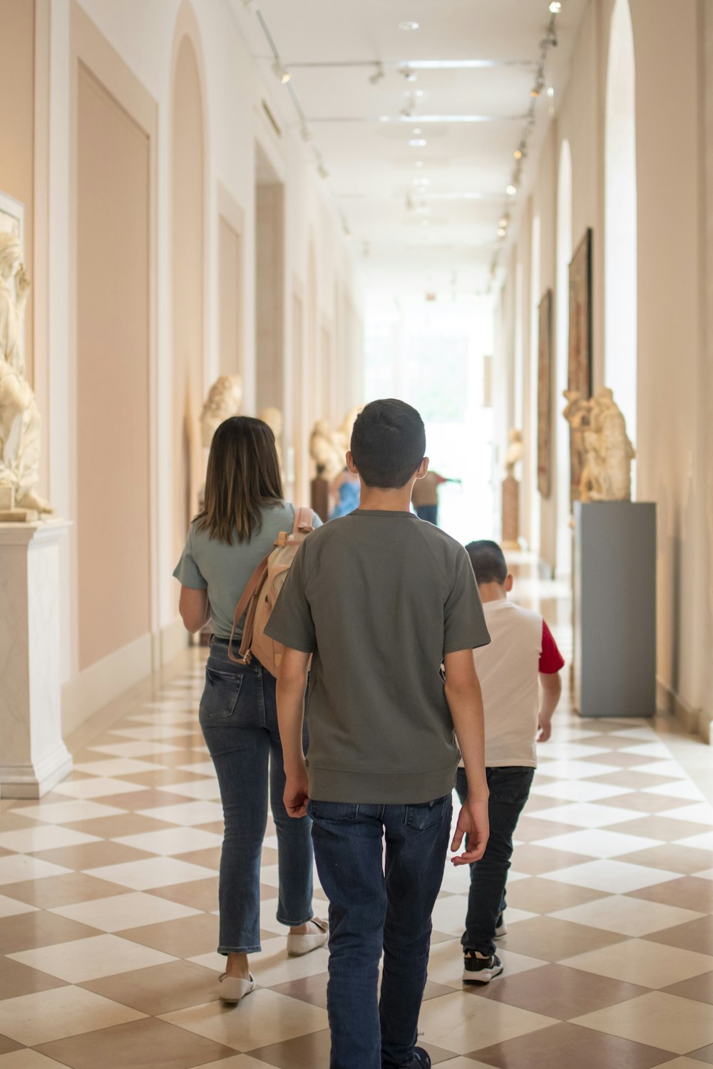 a group of people walking in a hallway