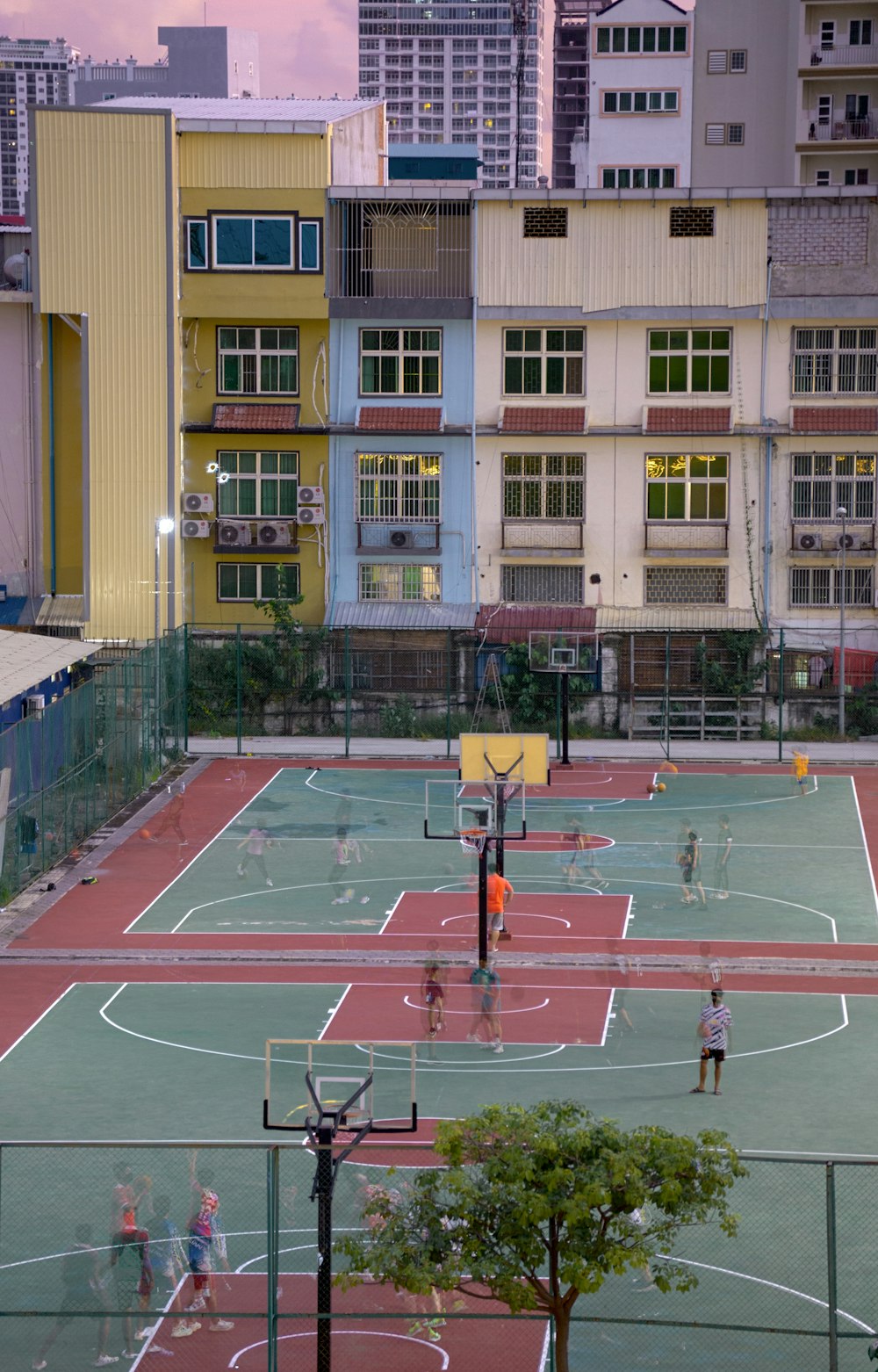 a group of people playing basketball