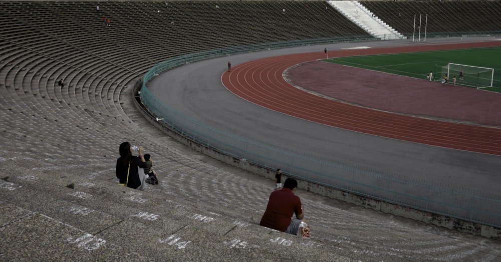 a group of people sitting on a stadium