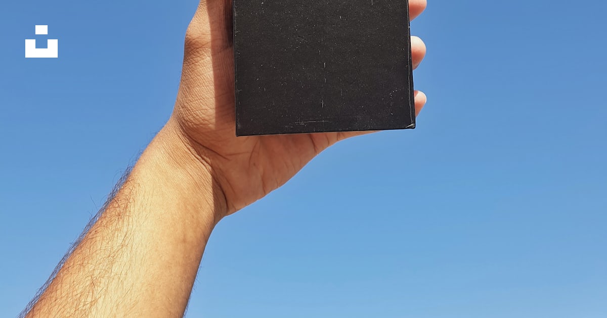 A hand holding a black rectangular device photo – Free Gandhinagar ...