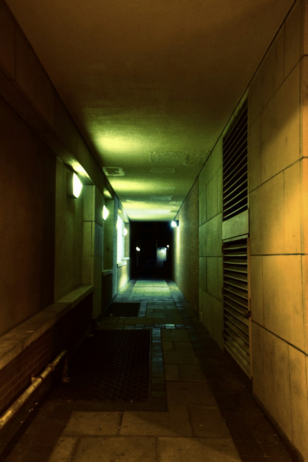 a hallway with a light on the end