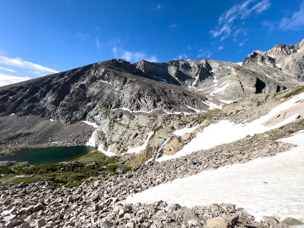 a rocky mountain with a lake