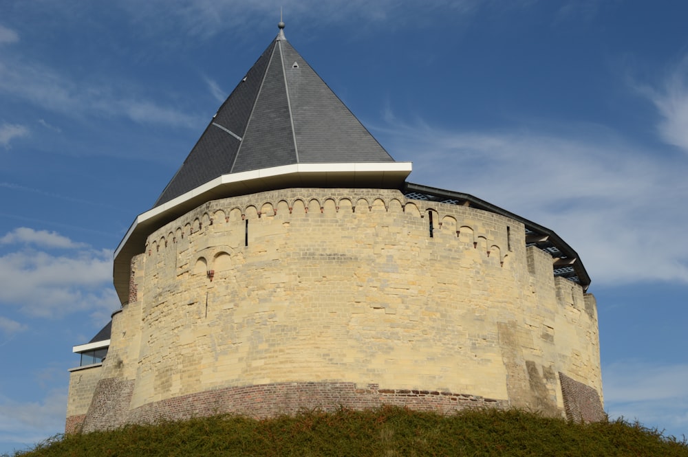 a stone building with a pointed roof