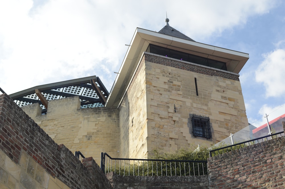 a stone building with a fence