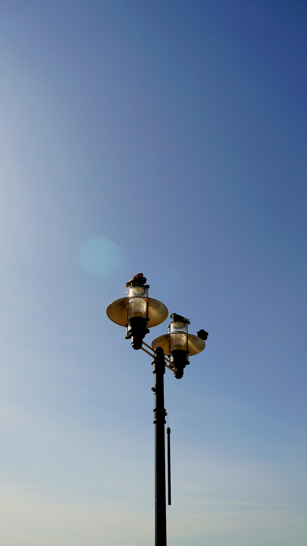 a light post with a blue sky