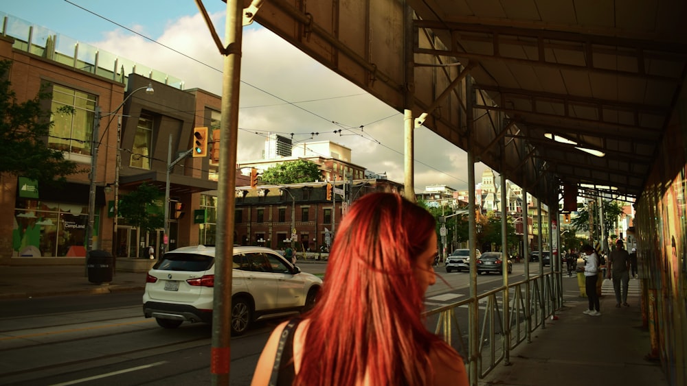 a woman walking on a sidewalk