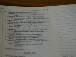 A welcoming group of diverse people gathered around a glowing Bible in a cozy room.