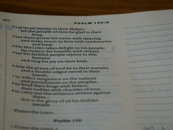 A warm church congregation gathered in worship with open Bibles and singing.