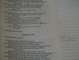 Text from a religious scripture is displayed on a page. It includes verses and appears to be a part of Psalm 149 and 150. There are printed lines alongside handwritten notes at the bottom.