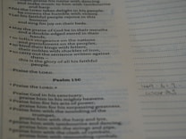 Text from a religious scripture is displayed on a page. It includes verses and appears to be a part of Psalm 149 and 150. There are printed lines alongside handwritten notes at the bottom.