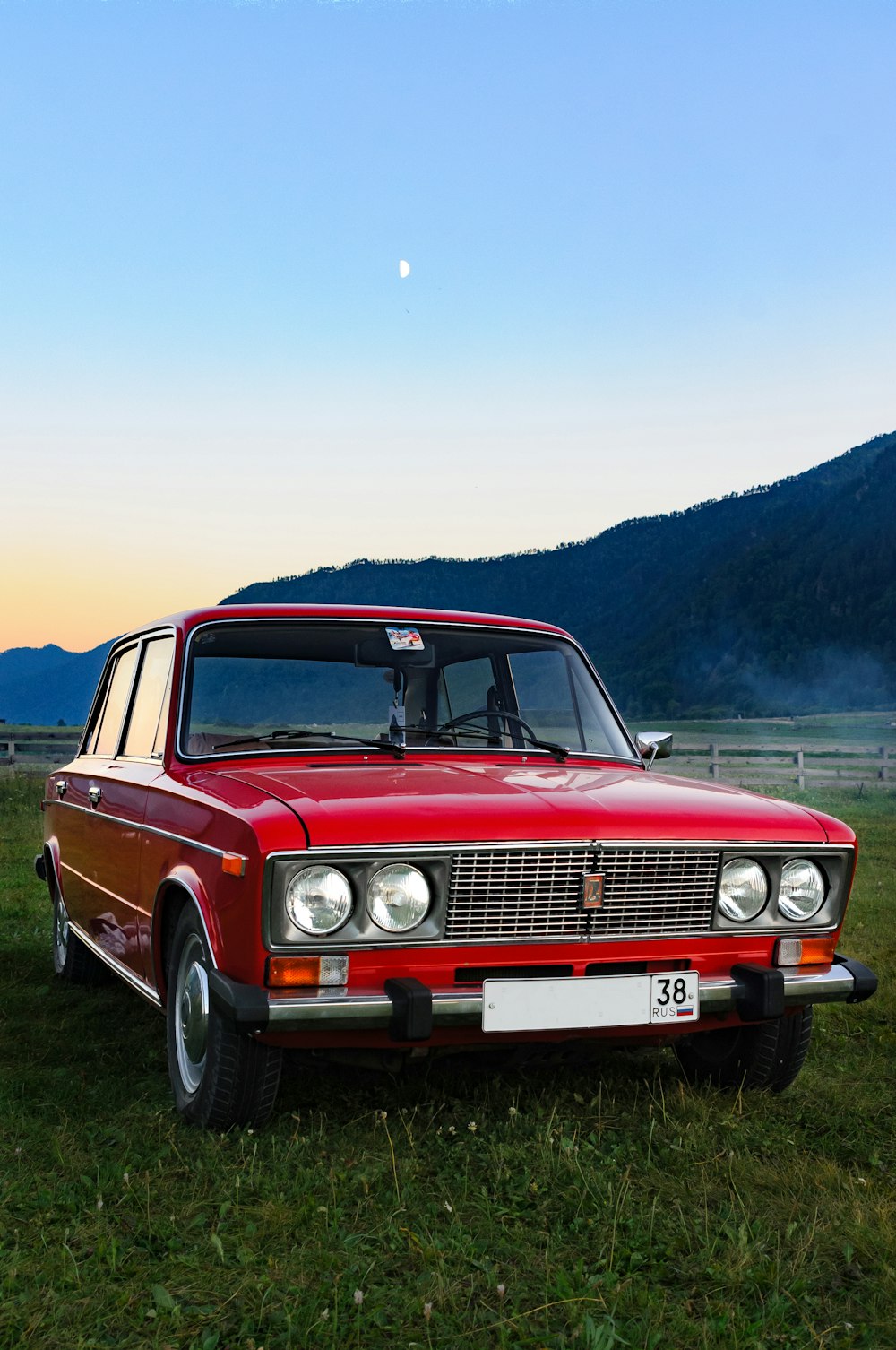 a red car parked in a field