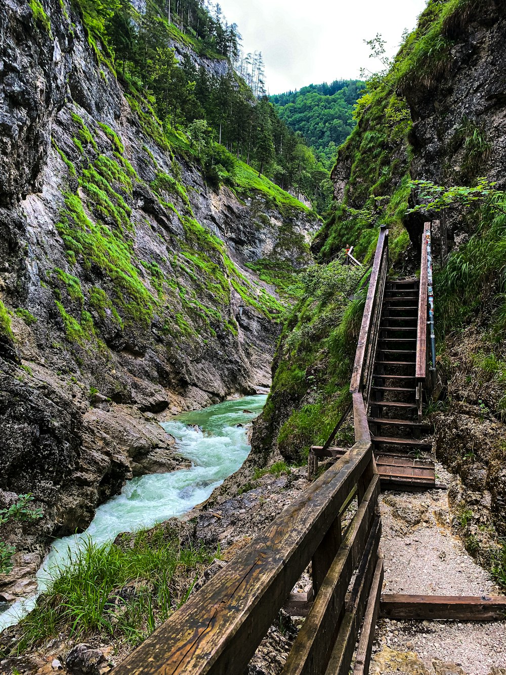 a wooden bridge over a river