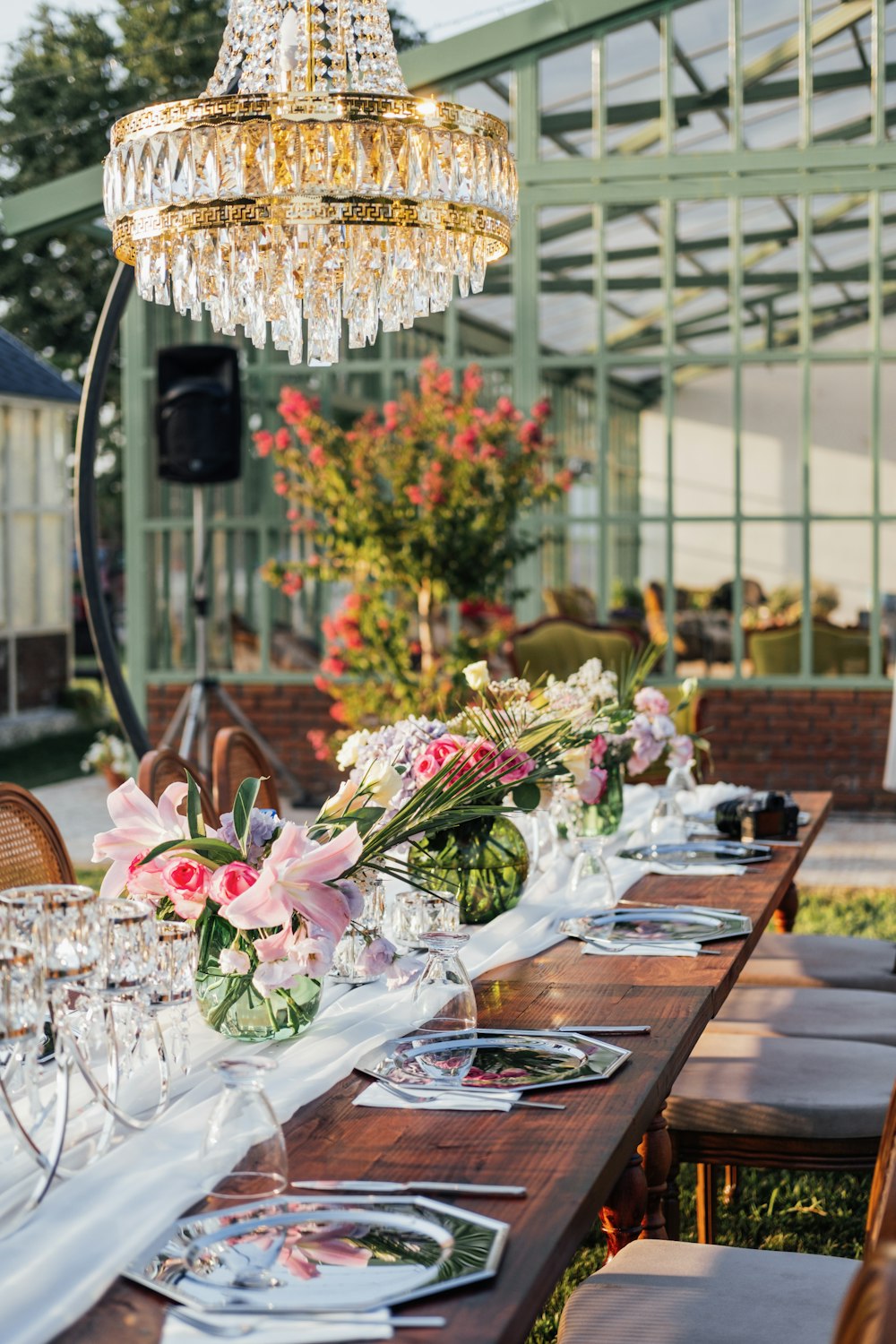 a table with flowers and glasses