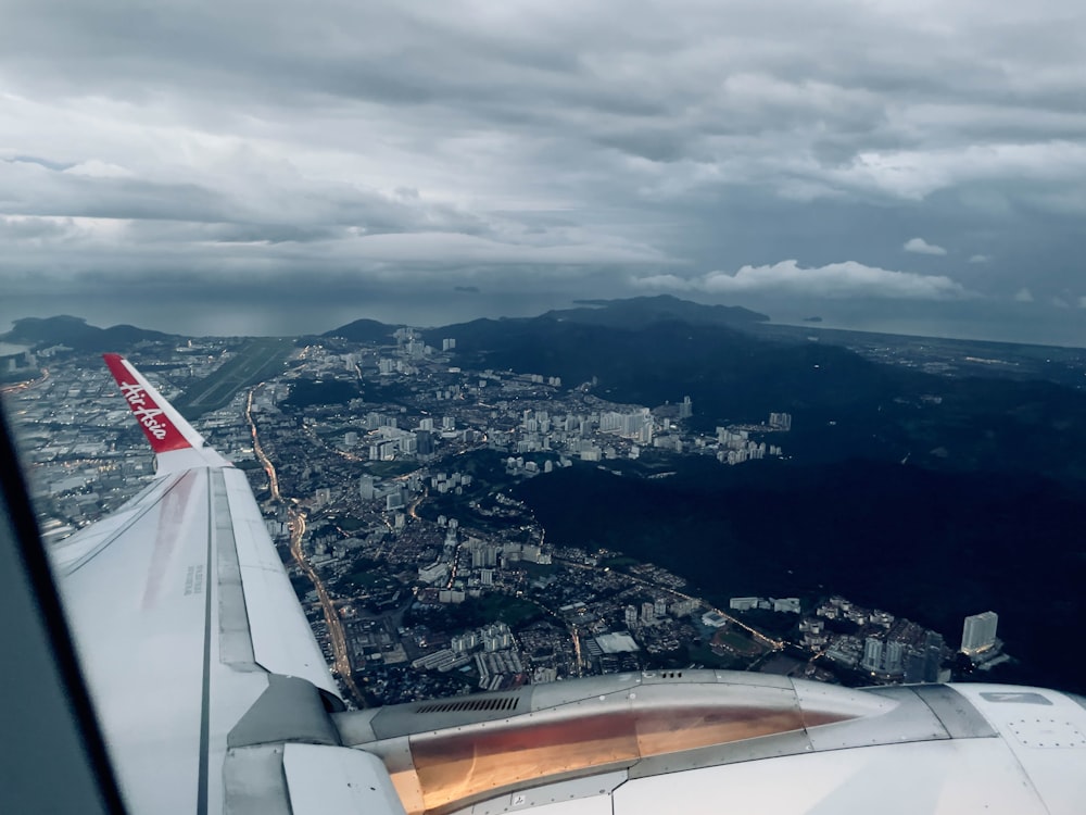 an airplane wing with a city below