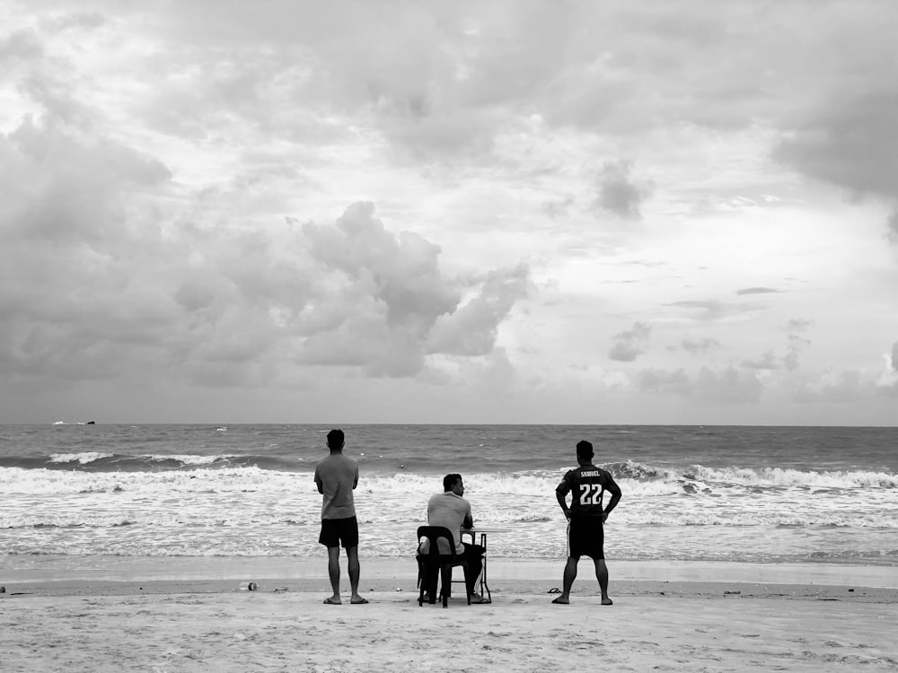 a group of people stand on a beach