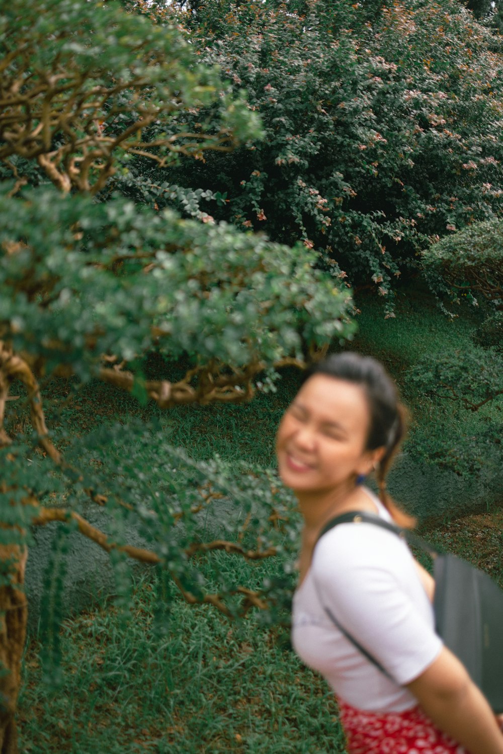 a person standing in front of a bush