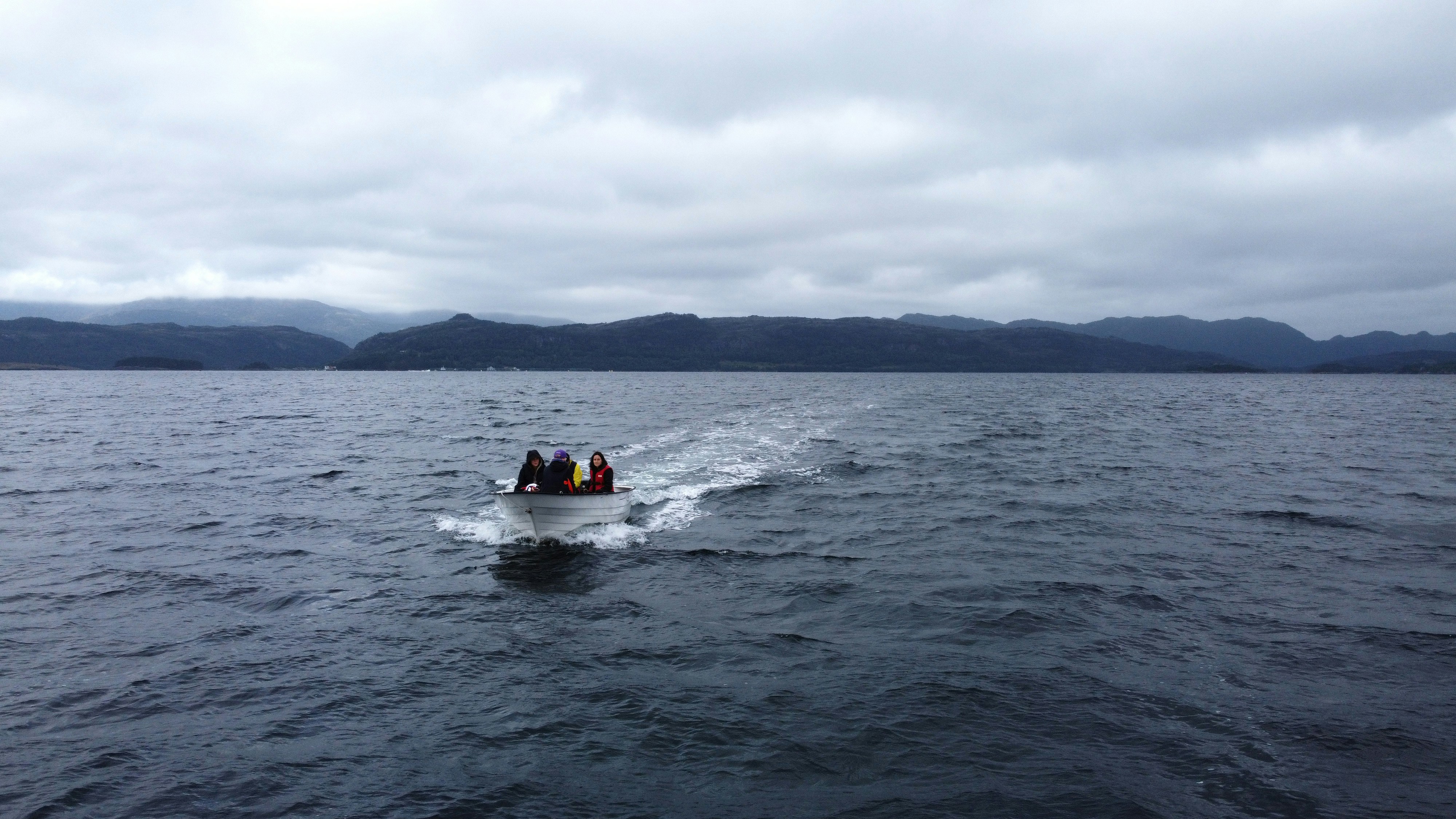 a group of people on a boat in the water