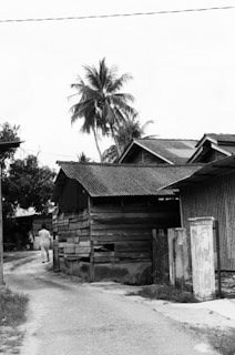 a person standing next to a wooden building