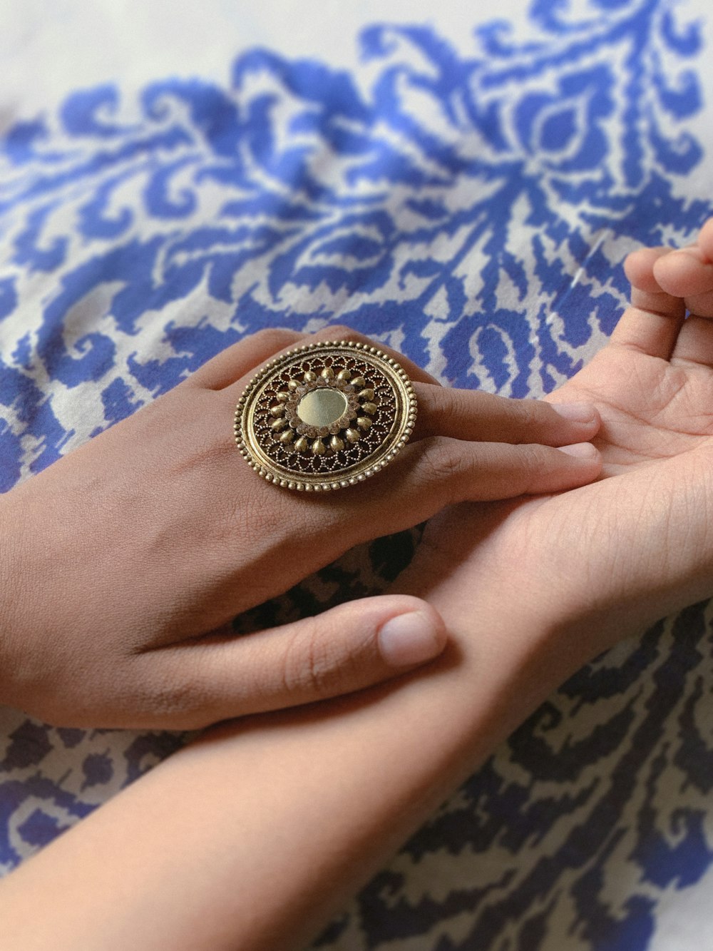 a hand holding a gold coin