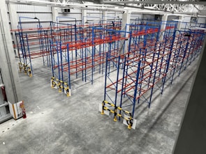 Wide shot of multiple autonomous robotic fire suppression units deployed around a warehouse.