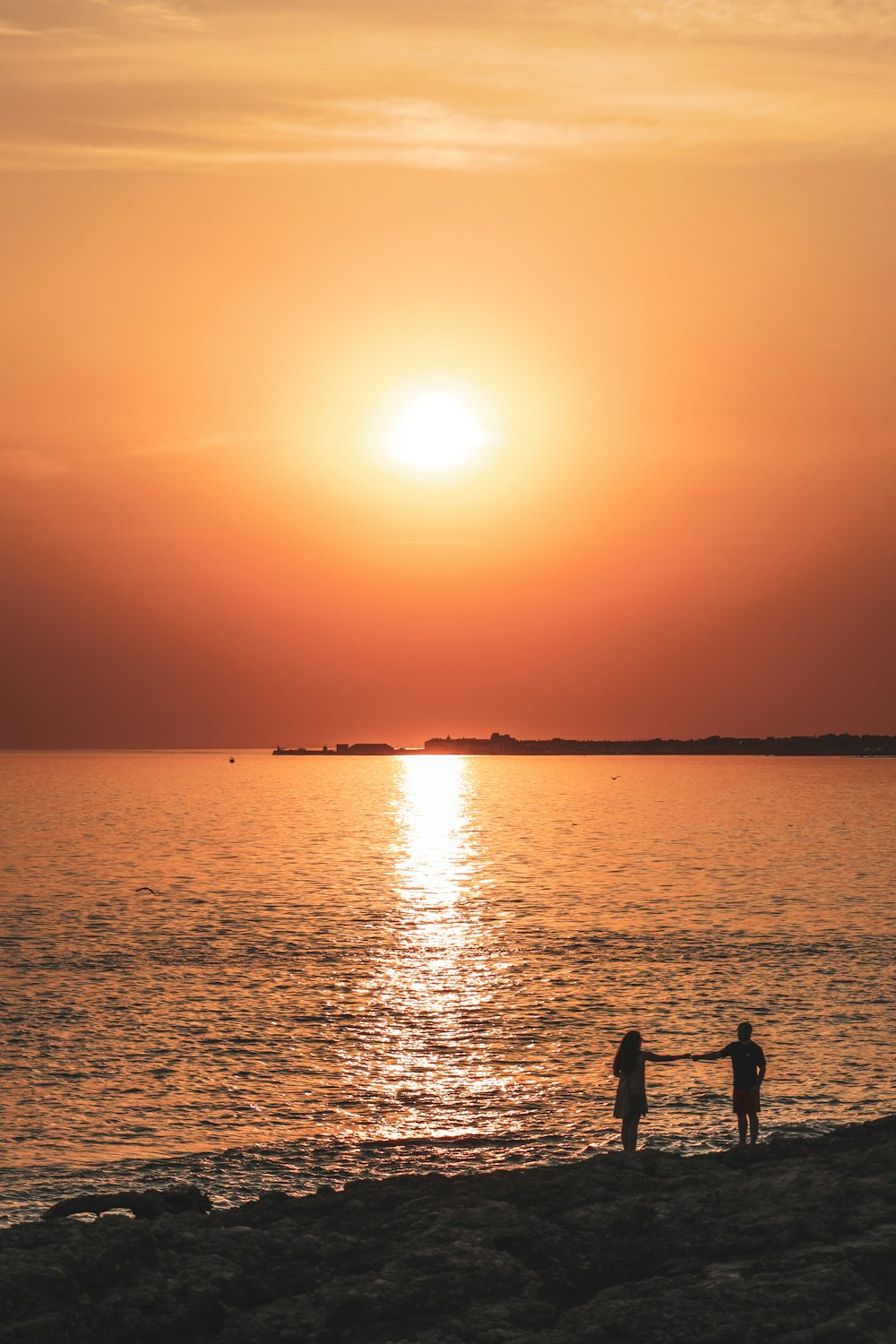 A couple of people fishing in the water at sunset photo – Free Sunset Image  on Unsplash
