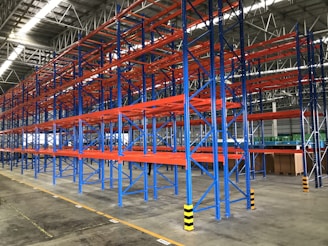 a warehouse with blue and yellow poles