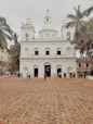 a large white building with a cross on top