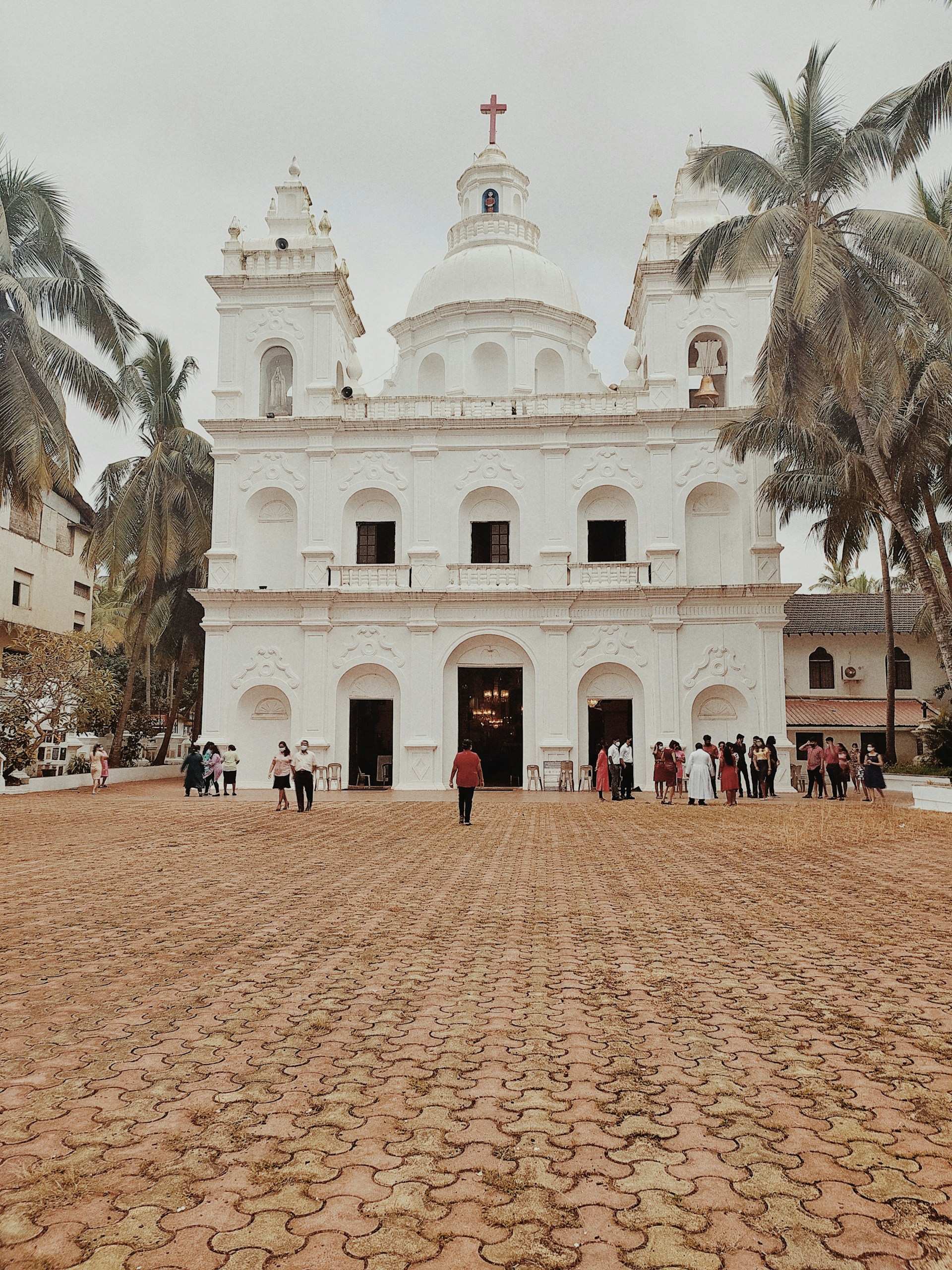 a large white building with a cross on top