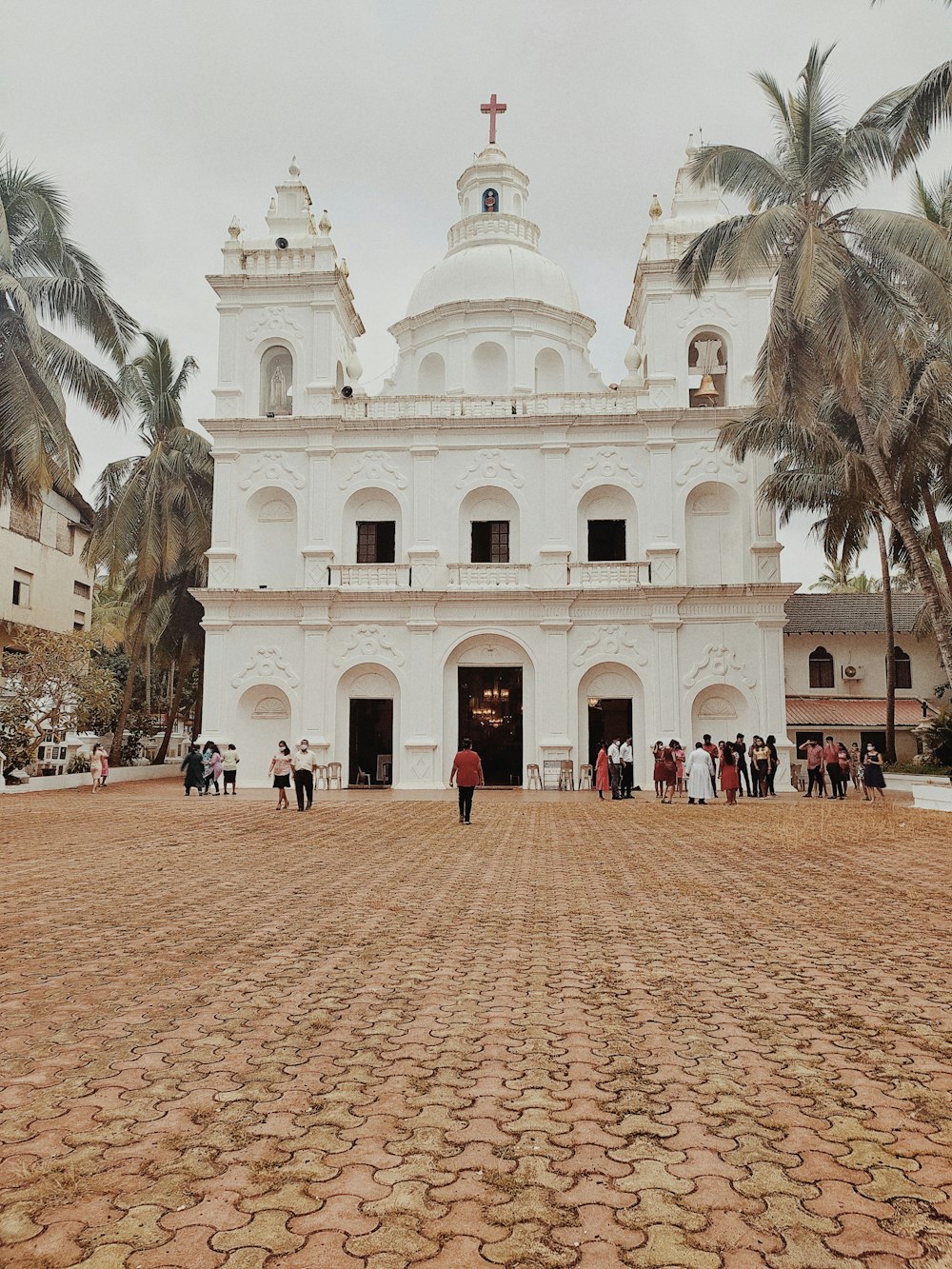 a large white building with a cross on top