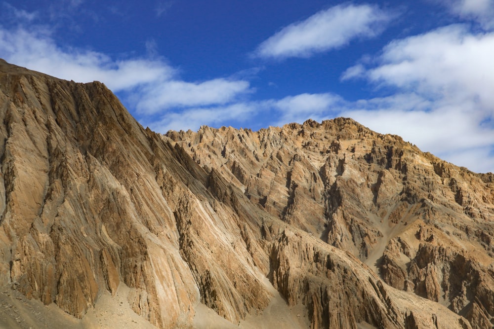 a rocky mountain with a blue sky