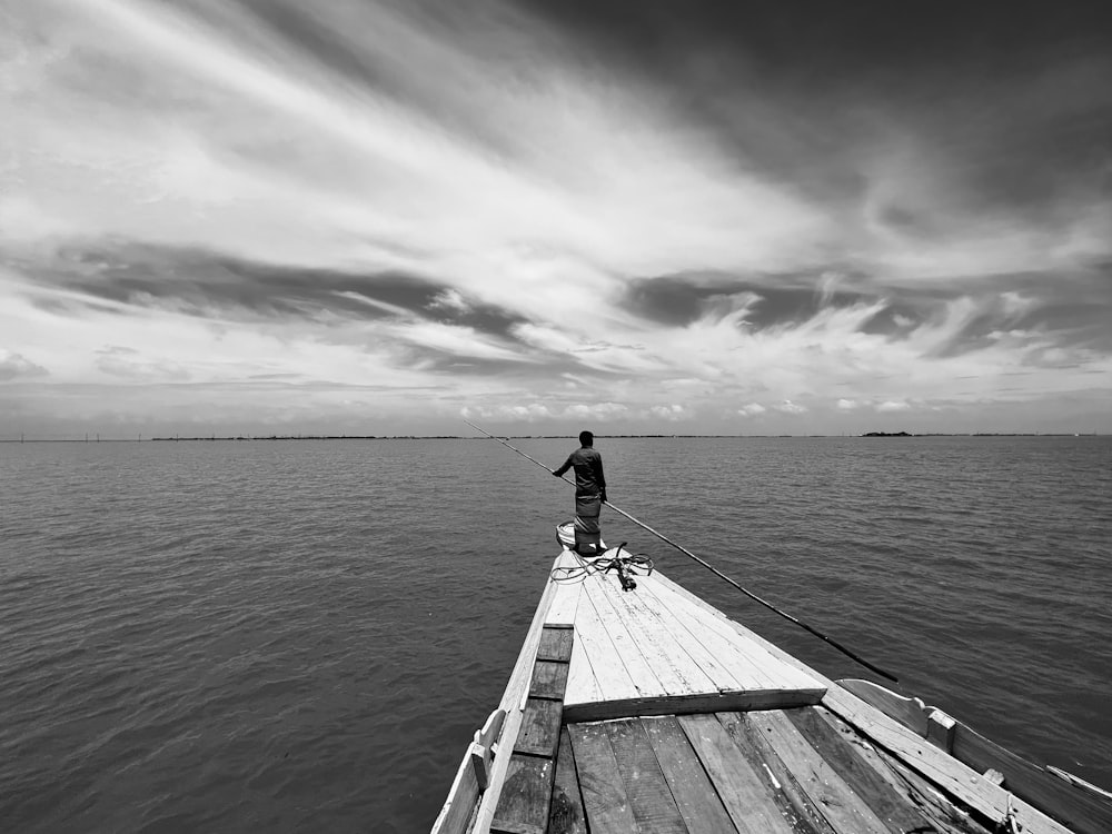 a person on a dock with a surfboard