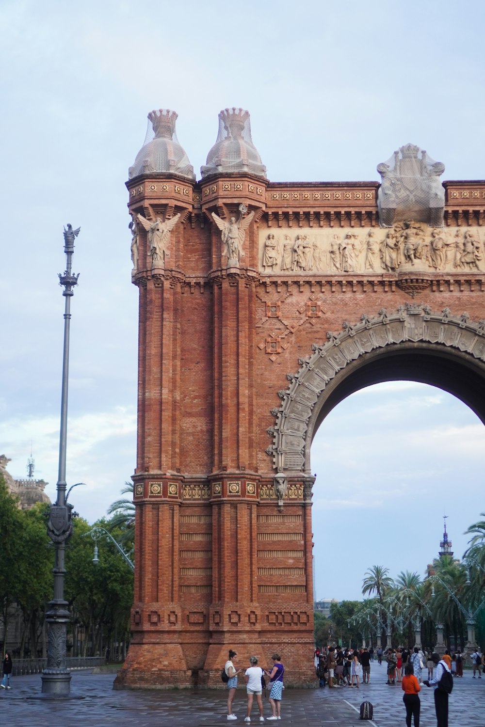 a large stone structure with a dome with Arc de Triomf in the background
