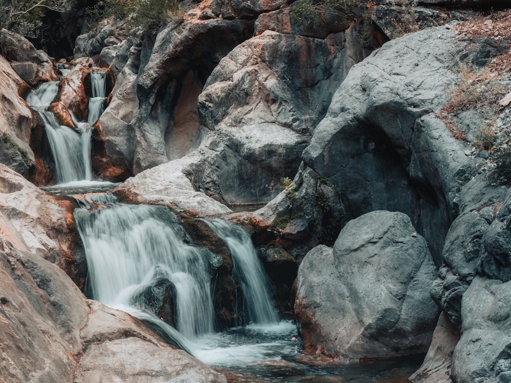 a large waterfall over a rocky cliff