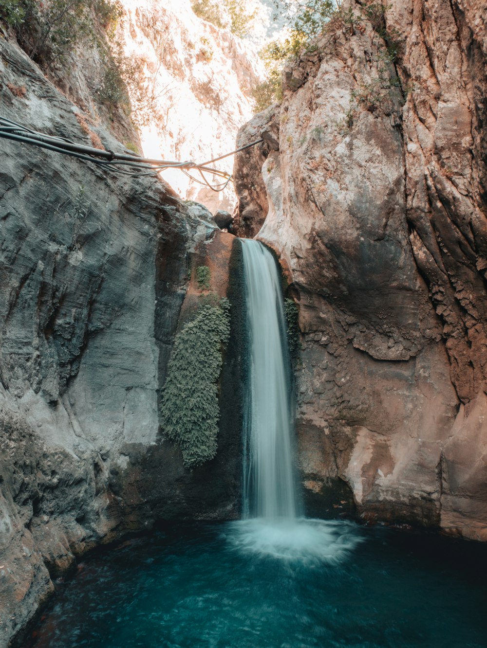 a large waterfall over a rock wall