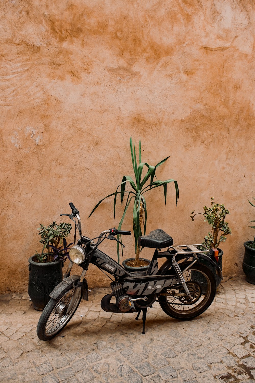 a motorcycle parked next to a wall