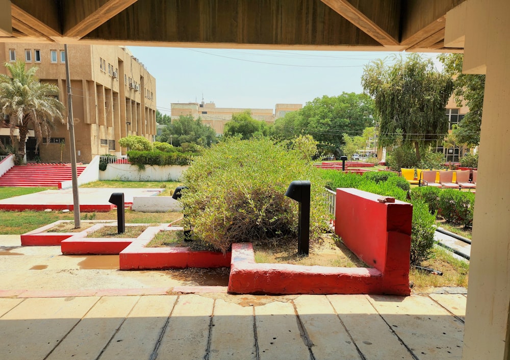 a courtyard with red benches and trees