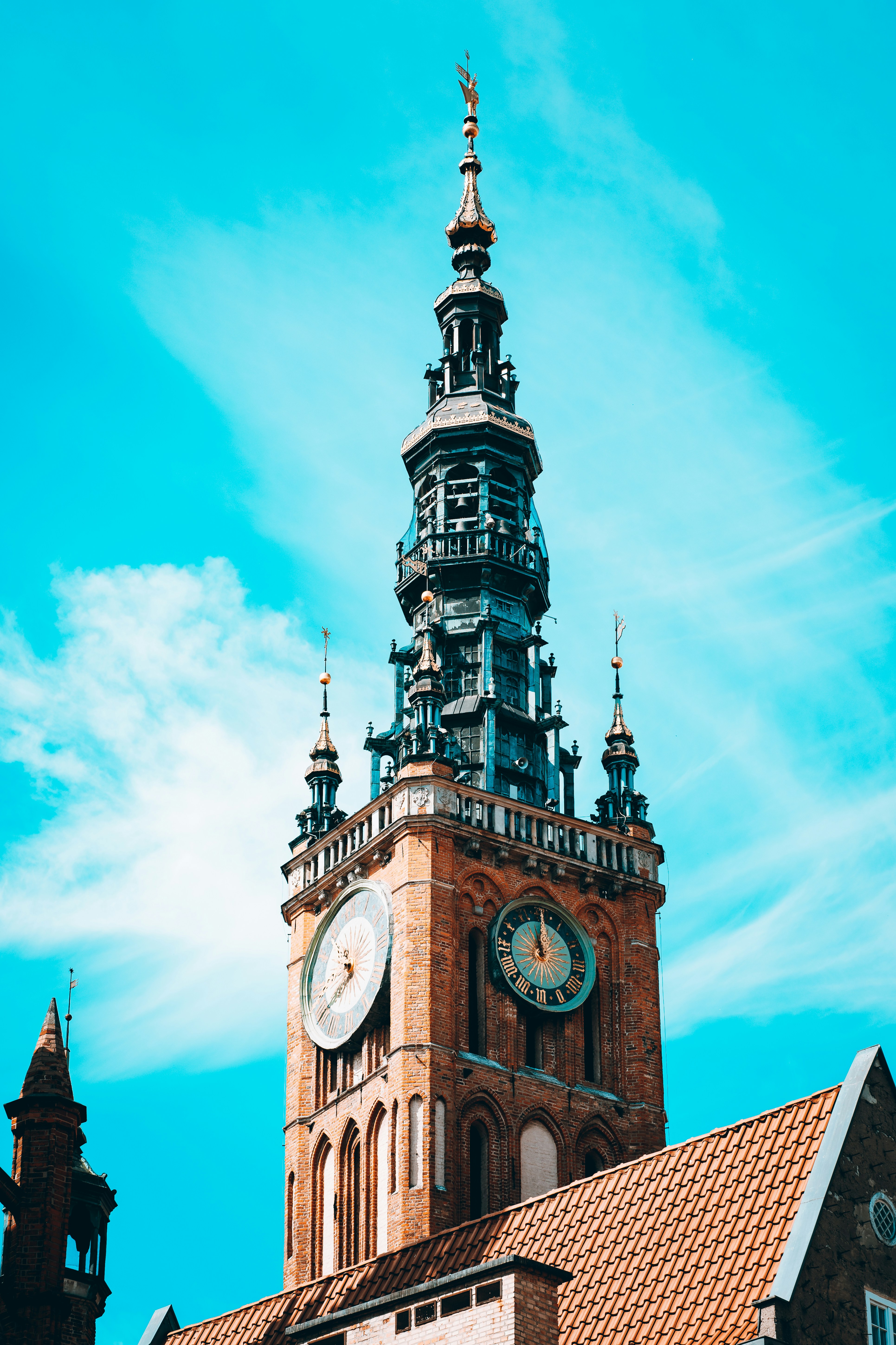 a clock tower with a weather vane