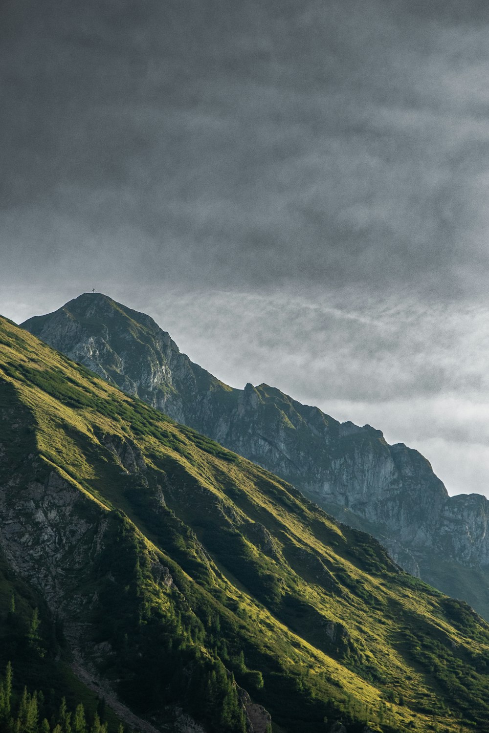 a mountain with clouds above it