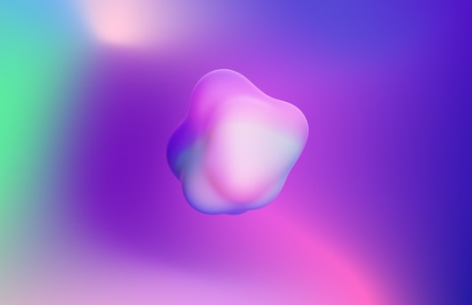 A fluid, violet-hued organic blob shape framing a serene landscape photo.