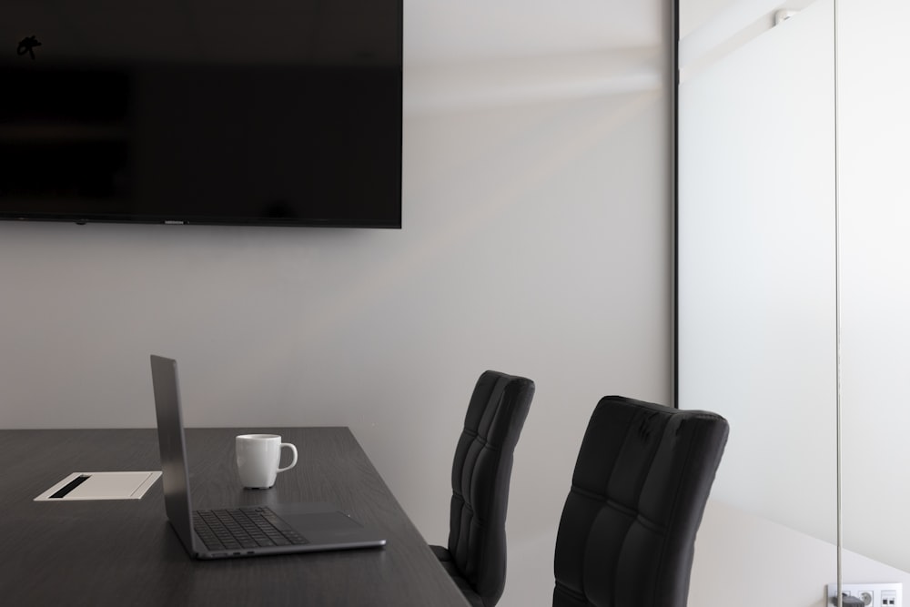 a desk with a laptop and a chair