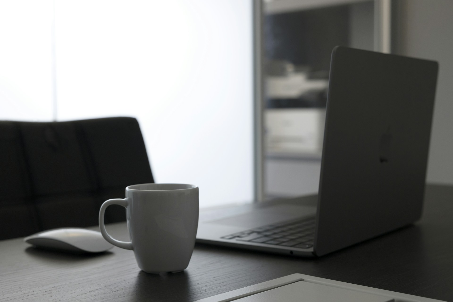 a laptop and a mug on a table
